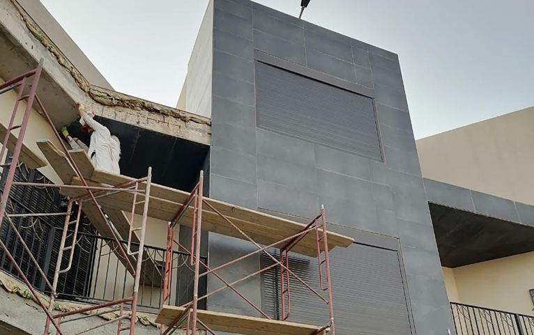 Modern grey facade cladding during installation
