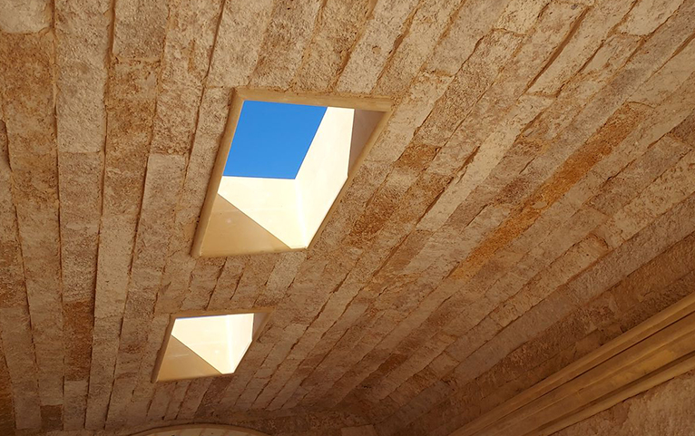 Textured stone ceiling with daylight openings